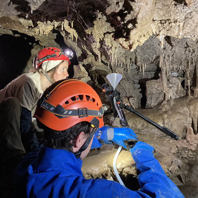 people collecting samples in a cave