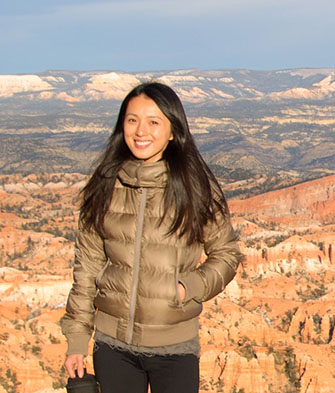 Corliss standing red-orange geologic landscape in background