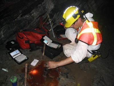 a scientist in a mine testing and collecting ancient groundwater