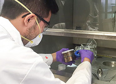 scientist working at a fume hood