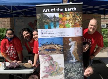 The Earth Sciences Science Rendezvous team posing behind the poster for the Art of the Earth exhibit.