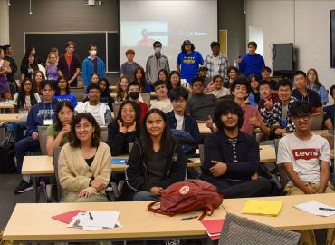 a large group of students in a classroom 